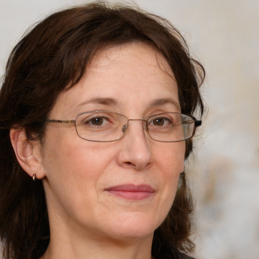 Joyful white adult female with medium  brown hair and blue eyes