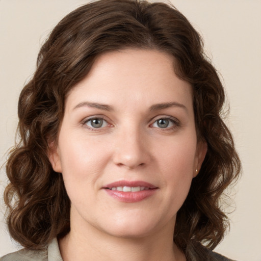 Joyful white young-adult female with medium  brown hair and green eyes