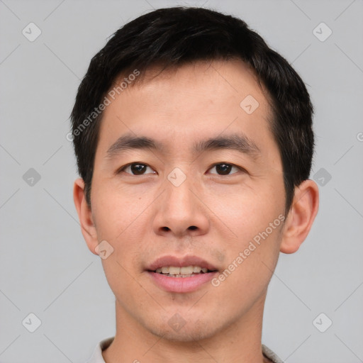 Joyful asian young-adult male with short  black hair and brown eyes