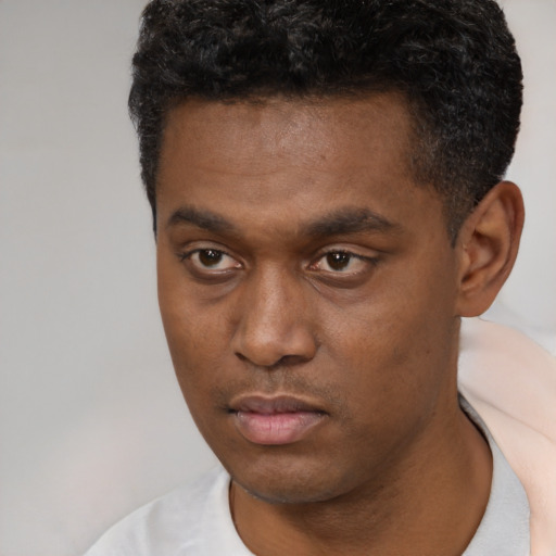 Neutral black young-adult male with short  black hair and brown eyes
