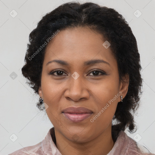 Joyful black adult female with medium  brown hair and brown eyes