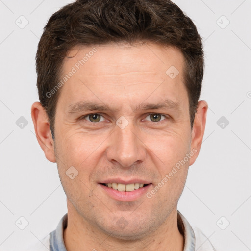 Joyful white adult male with short  brown hair and grey eyes