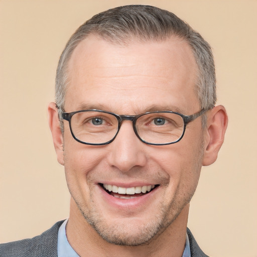 Joyful white adult male with short  brown hair and brown eyes