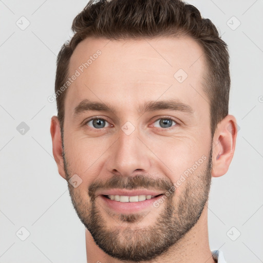 Joyful white young-adult male with short  brown hair and grey eyes