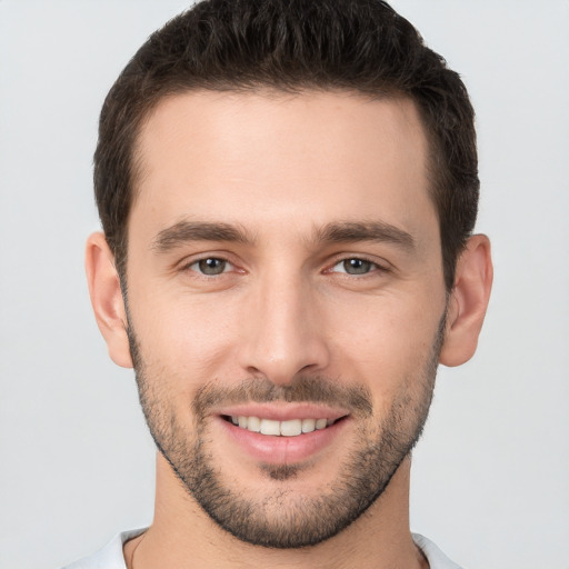 Joyful white young-adult male with short  brown hair and brown eyes