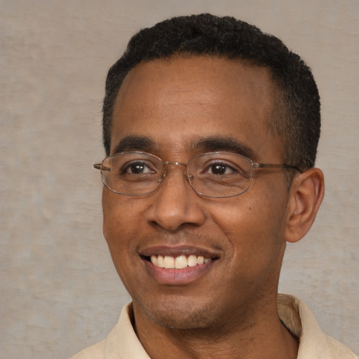 Joyful black adult male with short  black hair and brown eyes