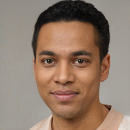 Joyful latino young-adult male with short  black hair and brown eyes