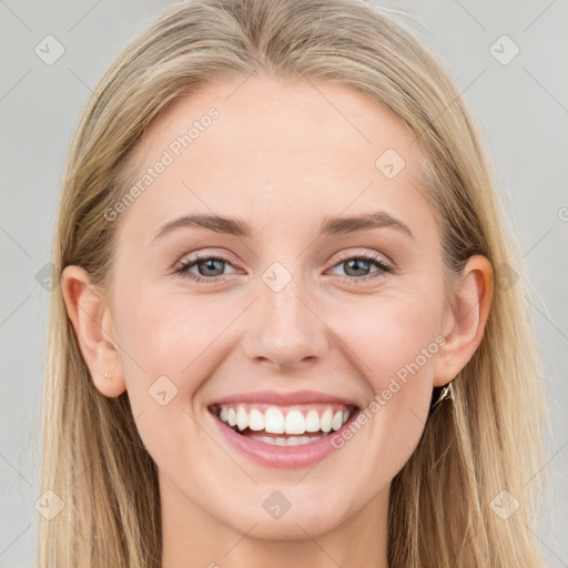 Joyful white young-adult female with long  brown hair and blue eyes