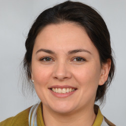 Joyful white young-adult female with medium  brown hair and brown eyes