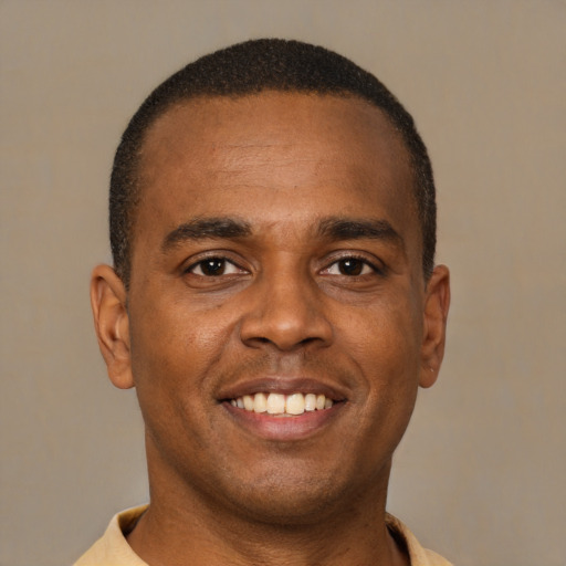Joyful latino young-adult male with short  brown hair and brown eyes