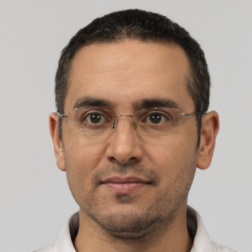 Joyful latino adult male with short  black hair and brown eyes