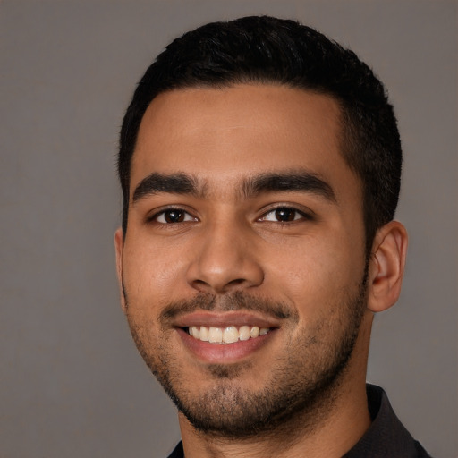 Joyful latino young-adult male with short  black hair and brown eyes