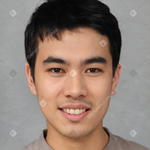 Joyful asian young-adult male with short  brown hair and brown eyes