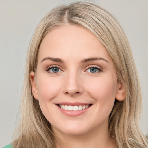 Joyful white young-adult female with long  brown hair and blue eyes