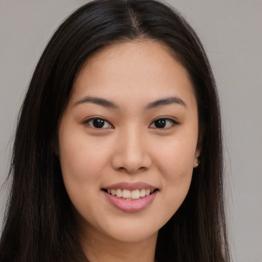 Joyful asian young-adult female with long  brown hair and brown eyes