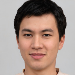 Joyful asian young-adult male with short  black hair and brown eyes