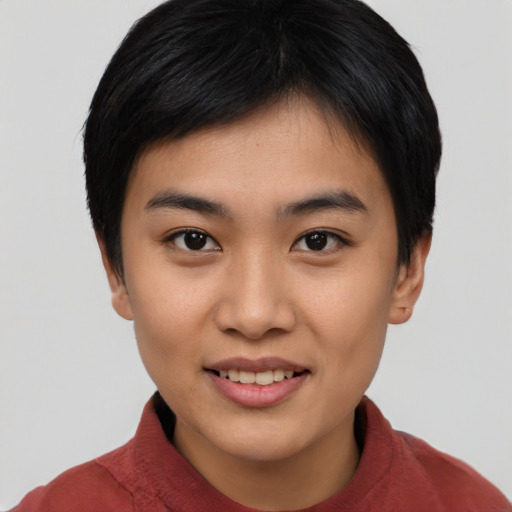 Joyful asian young-adult female with short  black hair and brown eyes