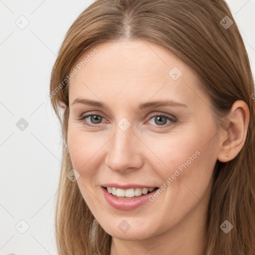 Joyful white young-adult female with long  brown hair and grey eyes