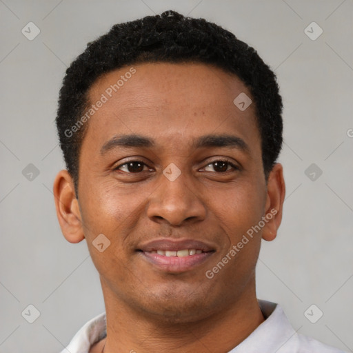 Joyful latino young-adult male with short  brown hair and brown eyes