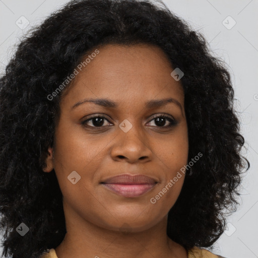 Joyful black young-adult female with long  brown hair and brown eyes