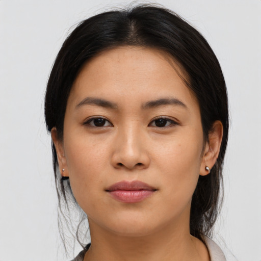 Joyful asian young-adult female with medium  black hair and brown eyes