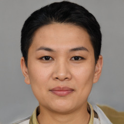 Joyful asian young-adult female with short  brown hair and brown eyes