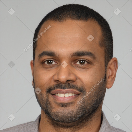 Joyful black young-adult male with short  black hair and brown eyes