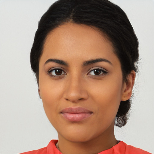 Joyful latino young-adult female with long  brown hair and brown eyes