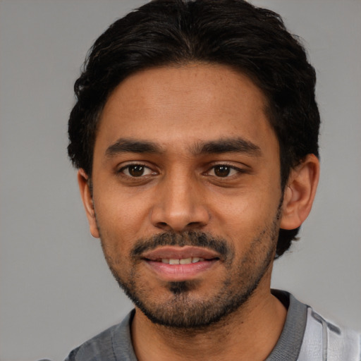 Joyful latino young-adult male with short  black hair and brown eyes
