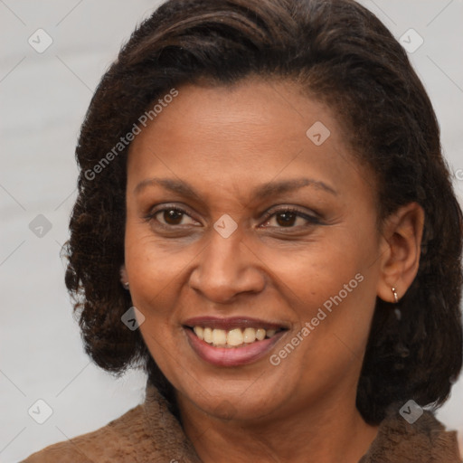 Joyful black adult female with medium  brown hair and brown eyes