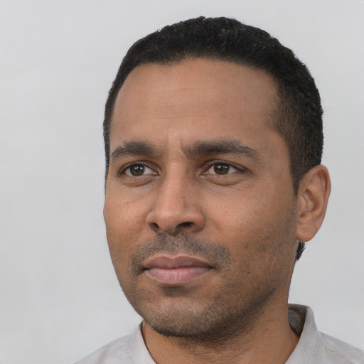 Neutral latino young-adult male with short  black hair and brown eyes
