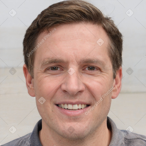 Joyful white adult male with short  brown hair and grey eyes