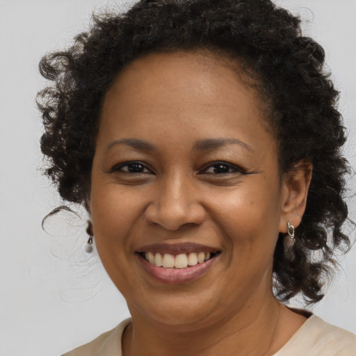 Joyful black young-adult female with medium  brown hair and brown eyes