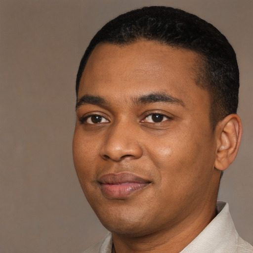 Joyful black young-adult male with short  black hair and brown eyes