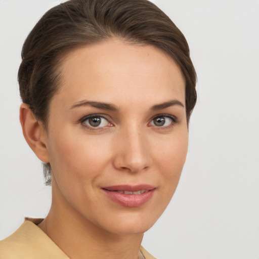 Joyful white young-adult female with short  brown hair and brown eyes