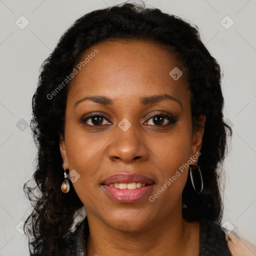 Joyful black adult female with long  brown hair and brown eyes