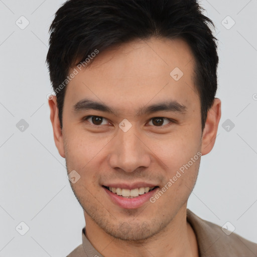 Joyful asian young-adult male with short  brown hair and brown eyes