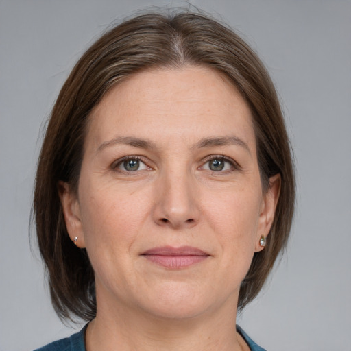 Joyful white adult female with medium  brown hair and grey eyes