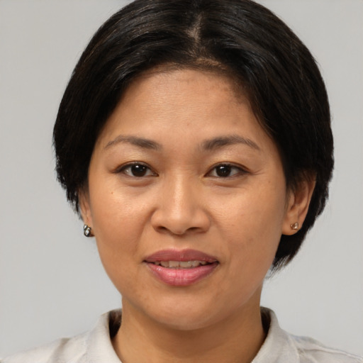 Joyful white adult female with medium  brown hair and brown eyes