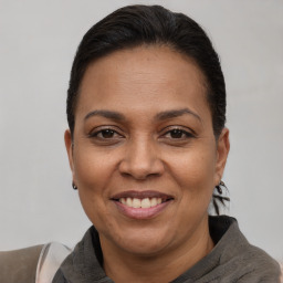 Joyful white adult female with short  brown hair and brown eyes