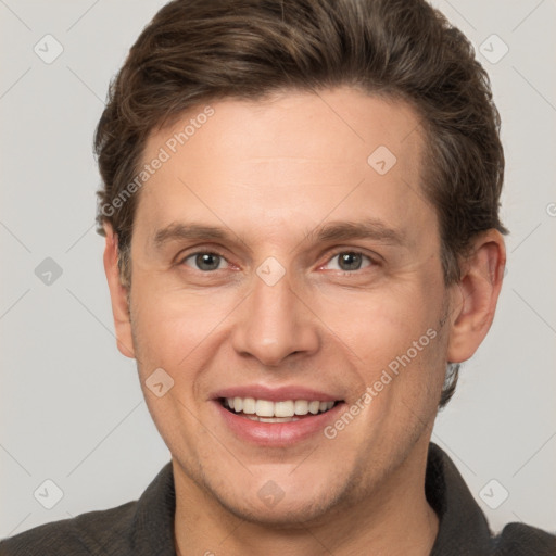 Joyful white adult male with short  brown hair and grey eyes