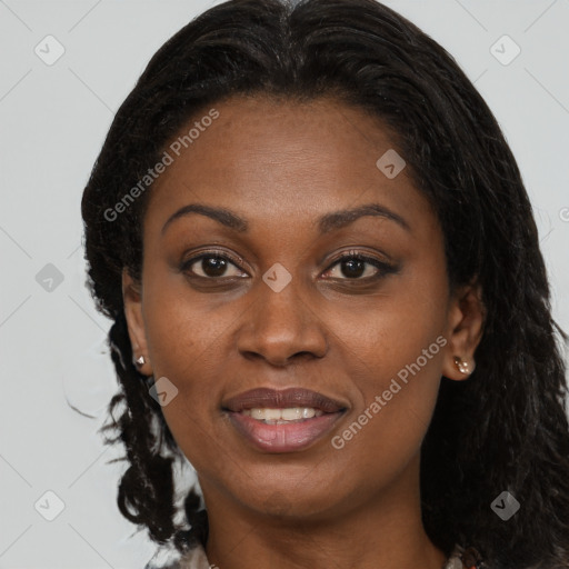 Joyful black young-adult female with long  brown hair and brown eyes