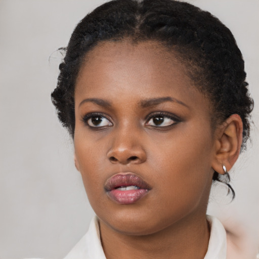 Neutral black young-adult female with medium  brown hair and brown eyes