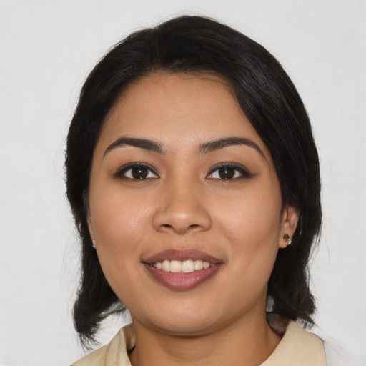 Joyful latino young-adult female with medium  black hair and brown eyes