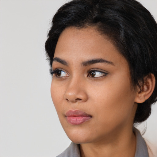 Neutral latino young-adult female with long  black hair and brown eyes