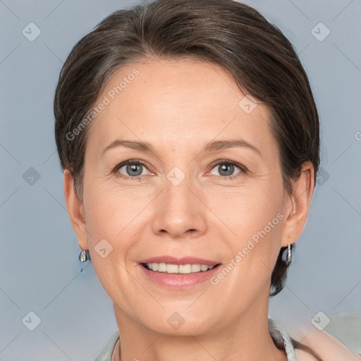 Joyful white adult female with medium  brown hair and grey eyes