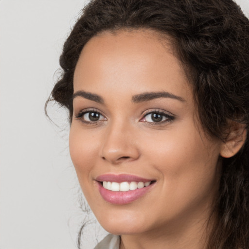 Joyful white young-adult female with long  brown hair and brown eyes