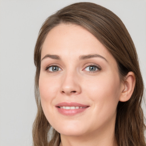 Joyful white young-adult female with long  brown hair and grey eyes