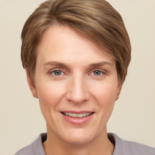 Joyful white adult female with short  brown hair and grey eyes