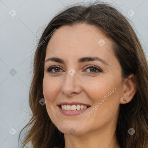 Joyful white adult female with long  brown hair and brown eyes